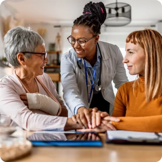 A support group setting showing a smiling woman talking to two other attentive women