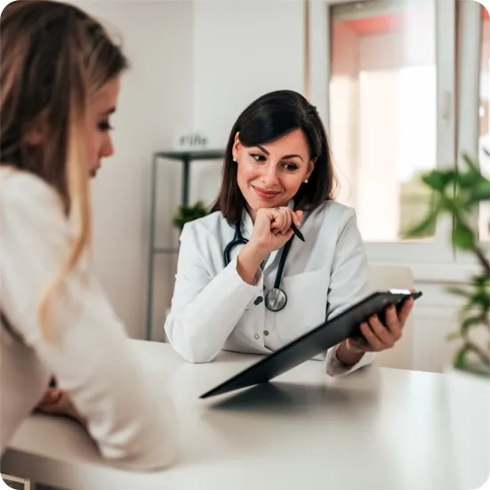 A doctor in a white coat consulting with a female patient