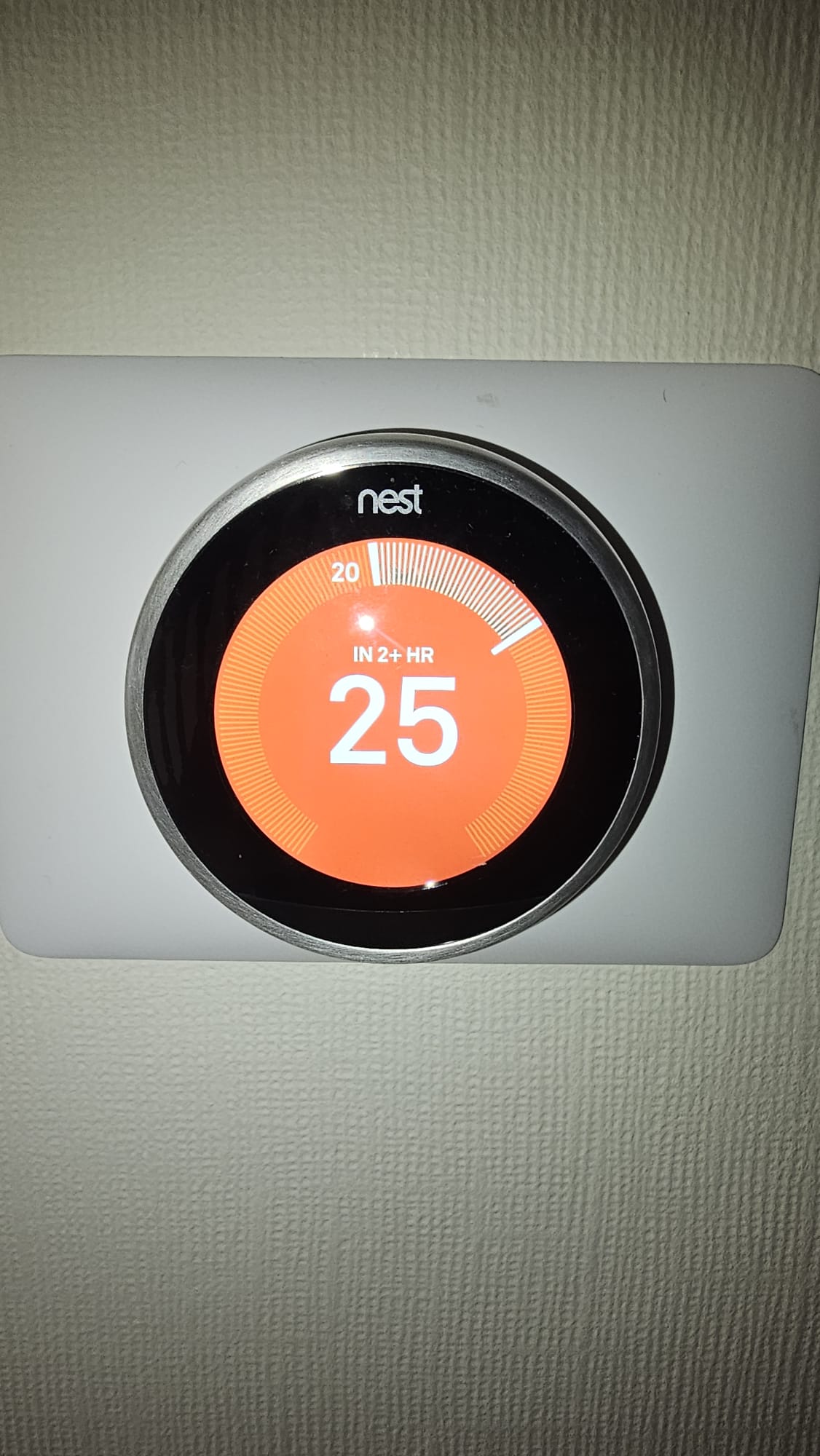 Google Nest smart thermostat displaying temperature on a wall-mounted control unit