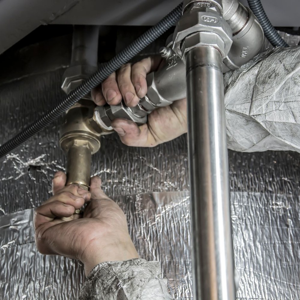 Plumber tightening pipe fittings