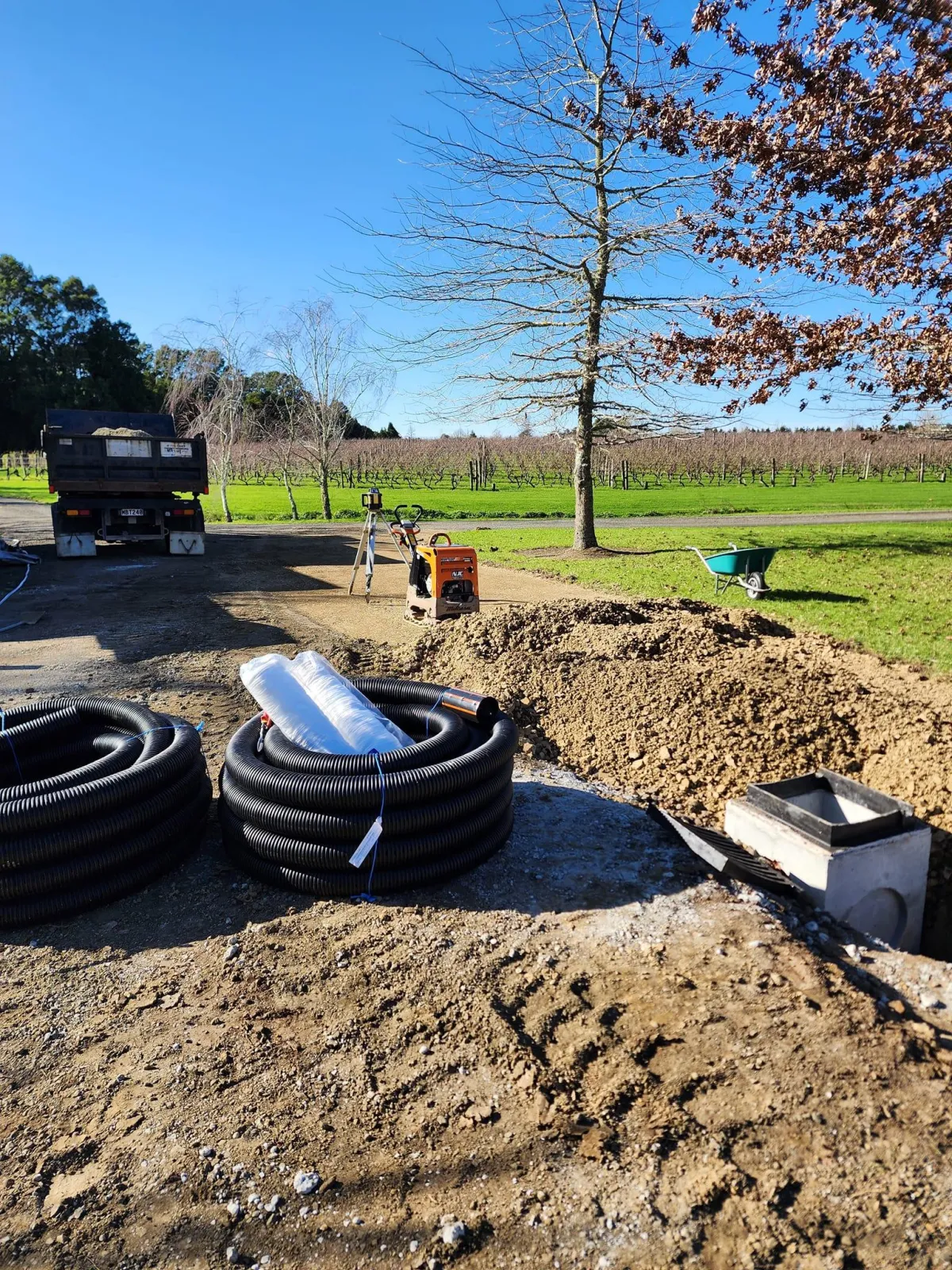Confined space entry with tripod safety rig and extraction hose during site work