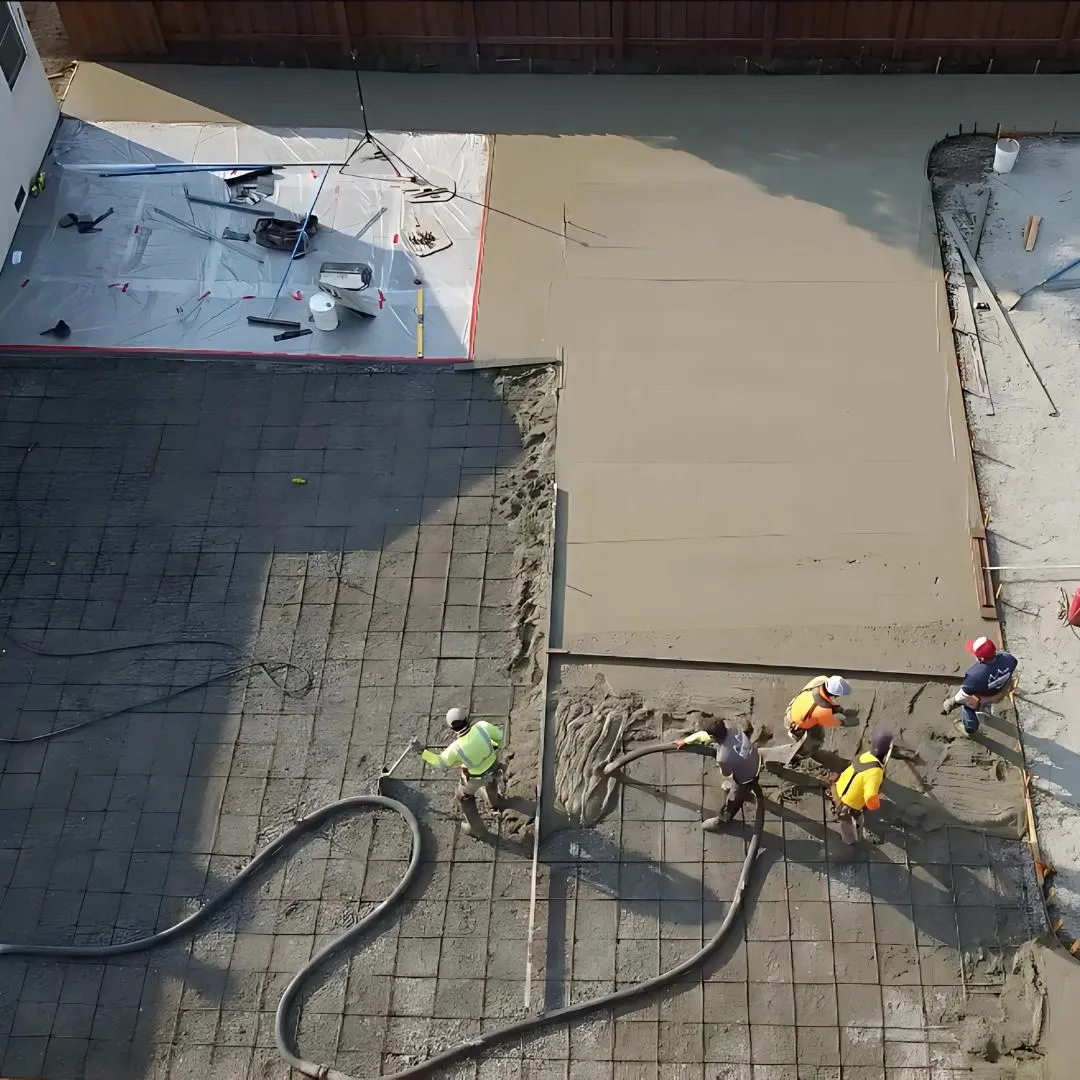 Concrete contractors pouring a concrete slab