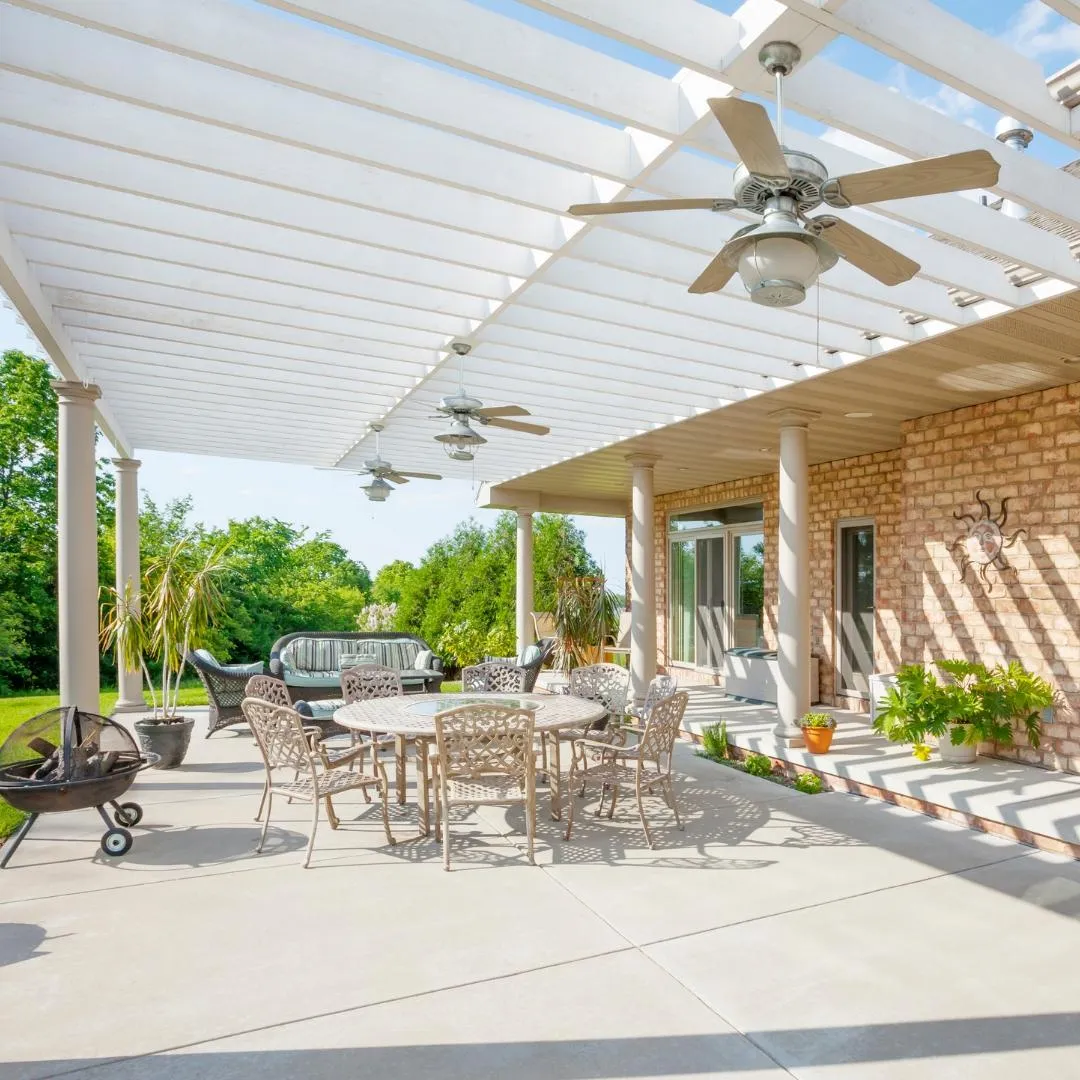 Concrete patio with table and chairs on a sunny day