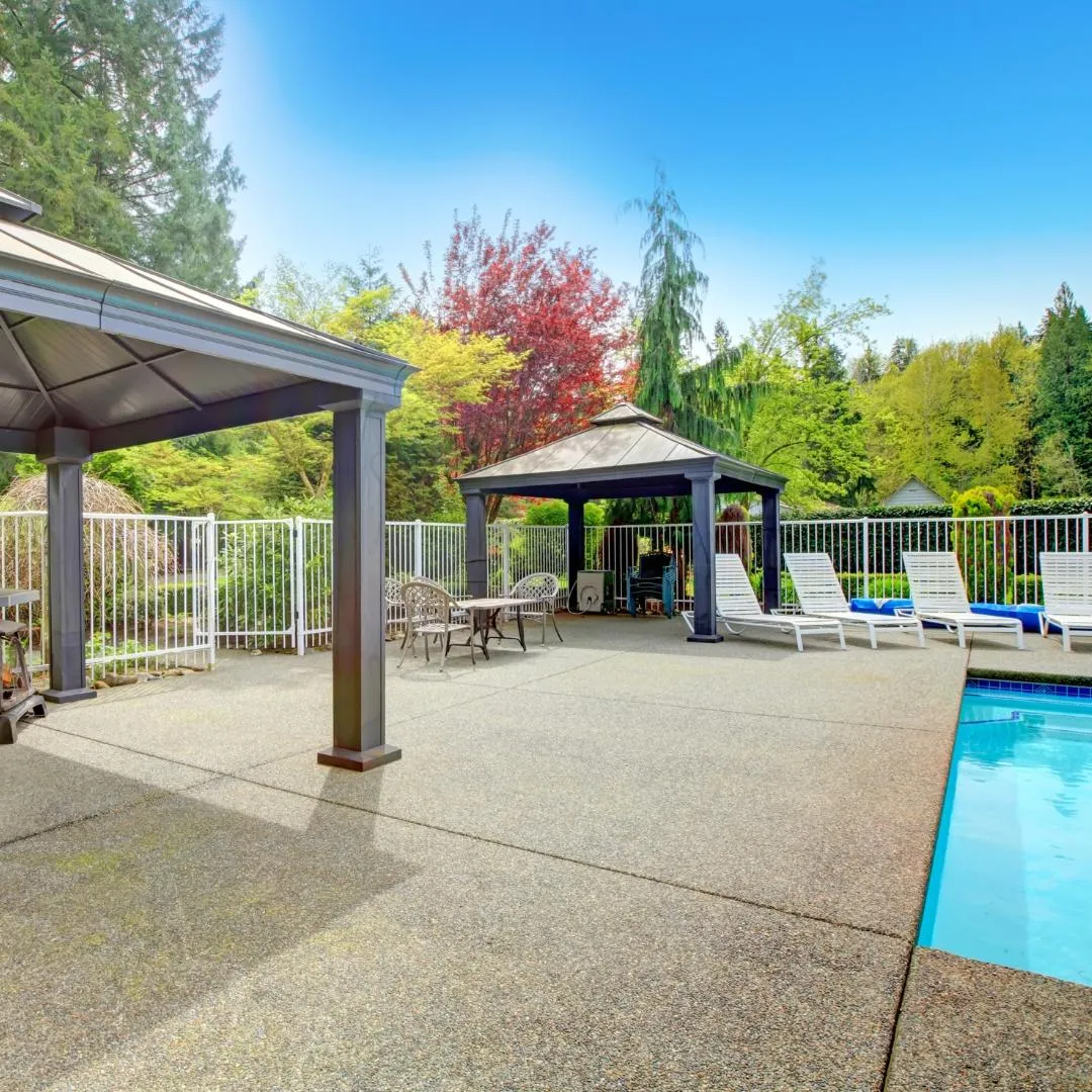 Concrete patio with pool and outdoor kitchen