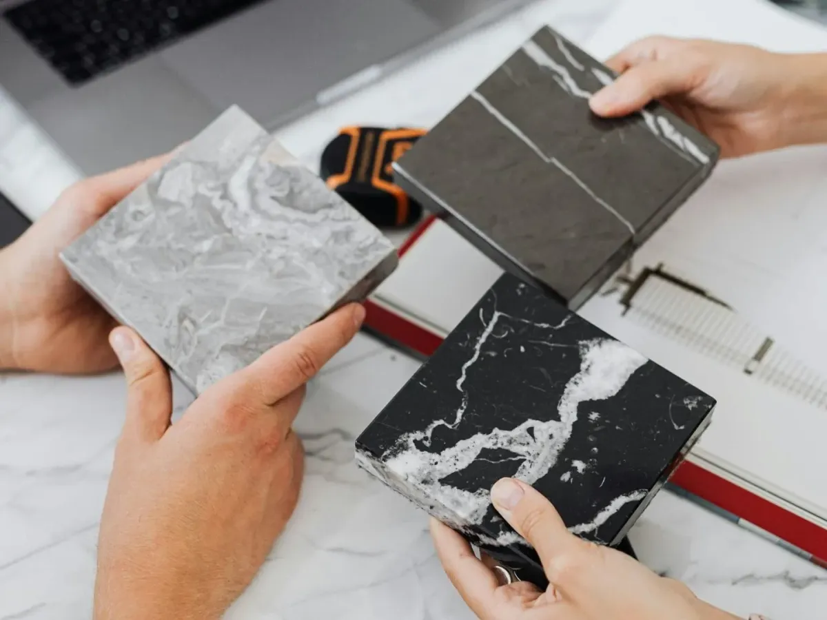 Newly renovated bathroom in Hampstead NC features marble floors, modern vanities, and sleek matte-black fixtures.