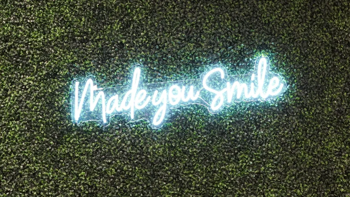 girl in white crew neck sweater smiling