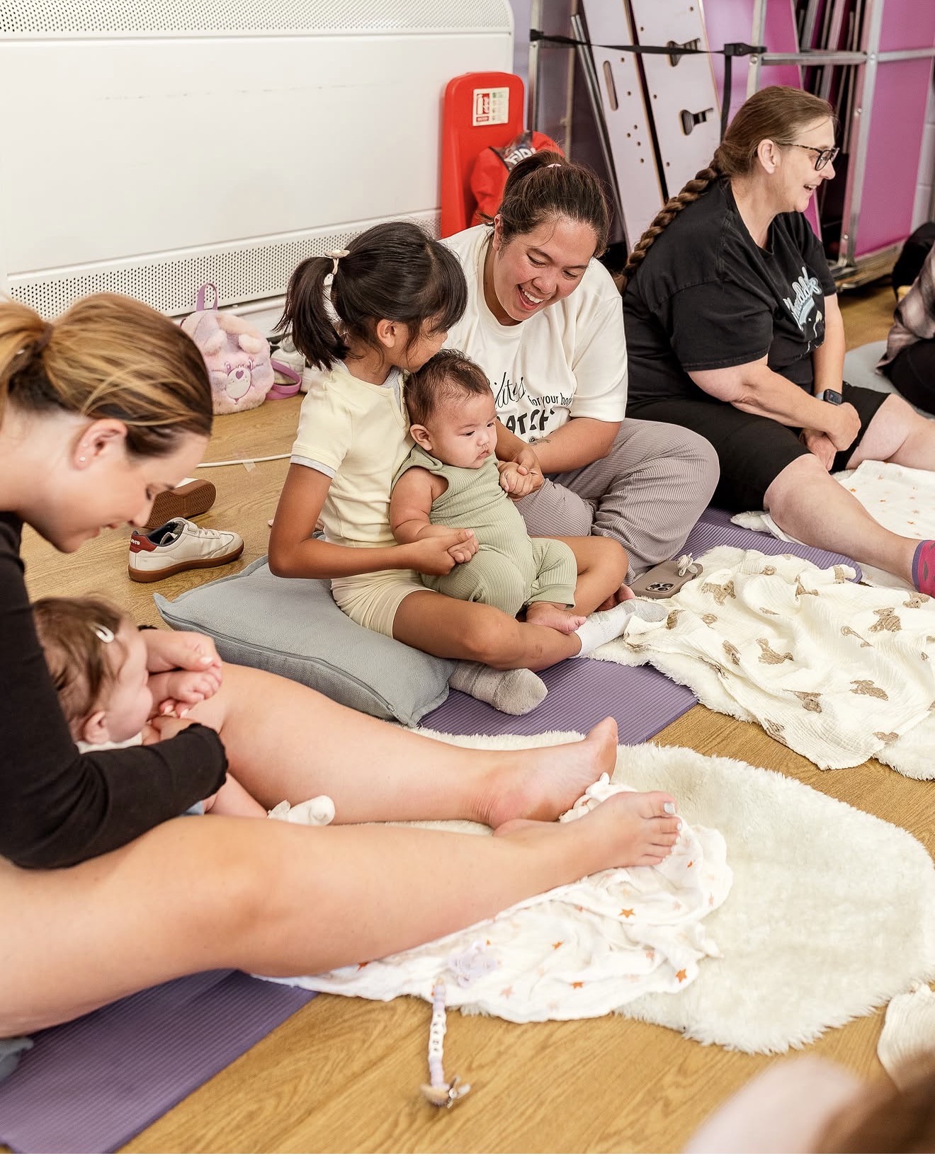 A community hall set up for a baby massage class
