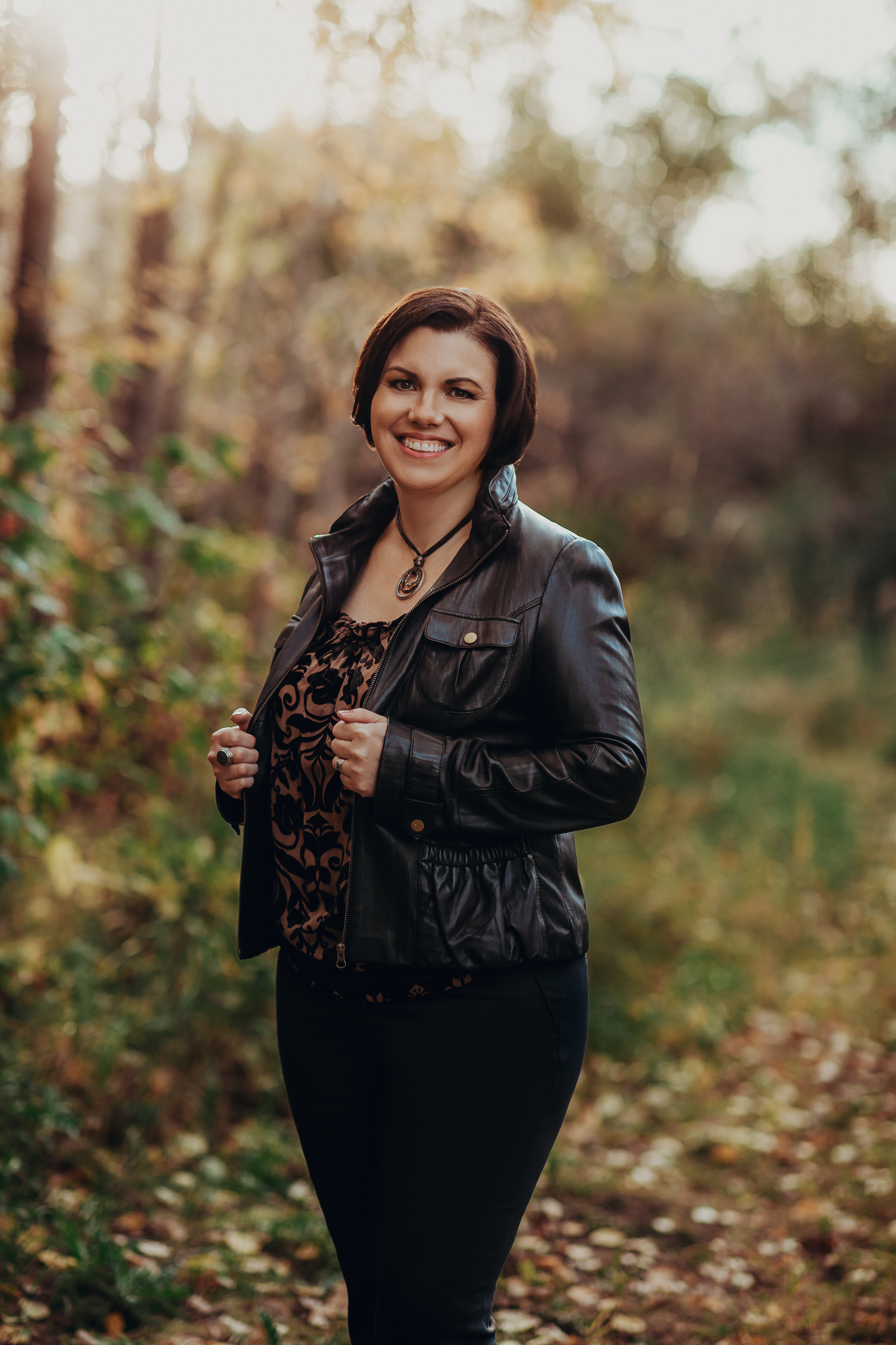 A soft, natural portrait in a sepia-toned reflective setting