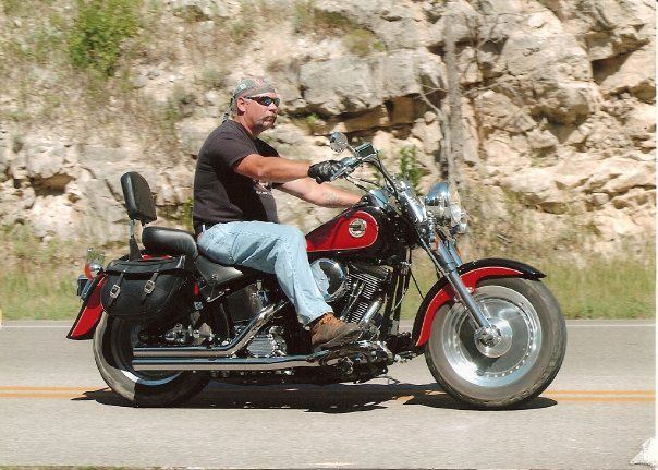 Motorcycle rider traveling, representing customers who choose our trailer rentals for reliable transport