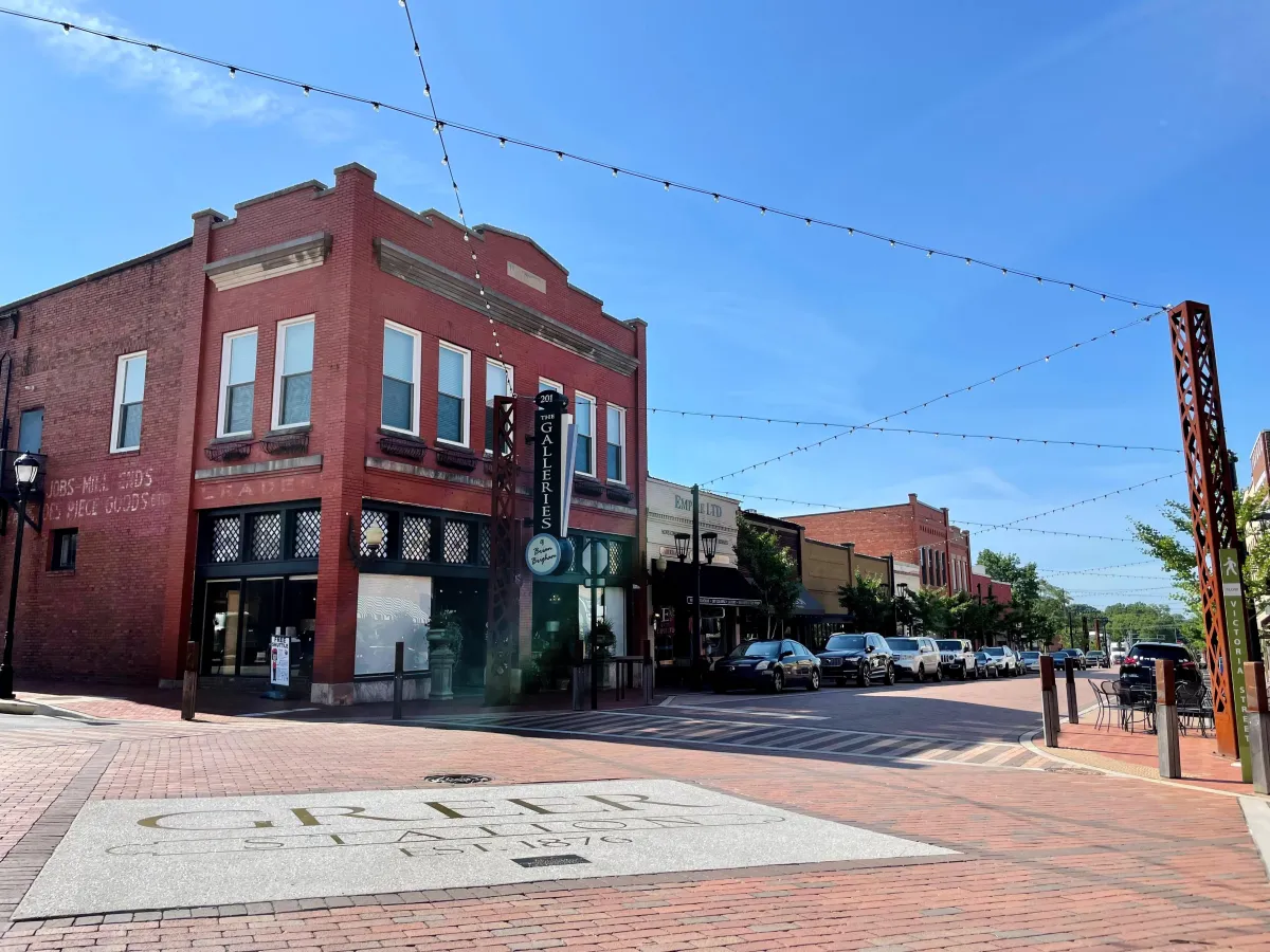 Water damage technician working on ceiling leak in Downtown Greer building