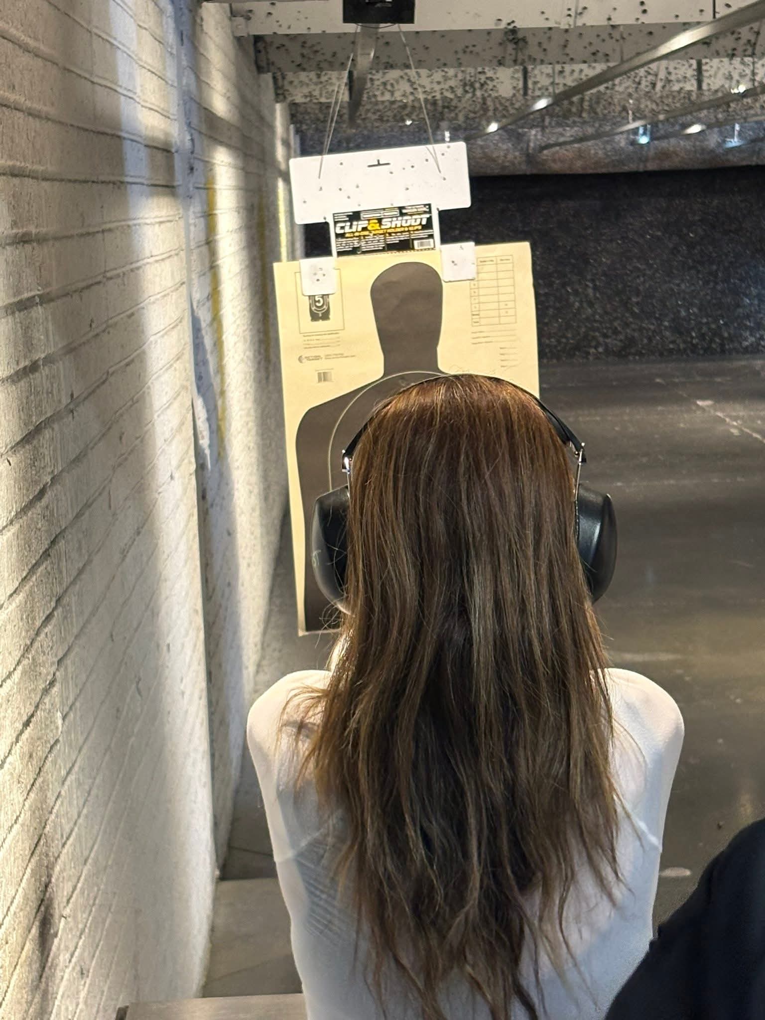 New shooter completing supervised live-fire handgun training at a shooting range