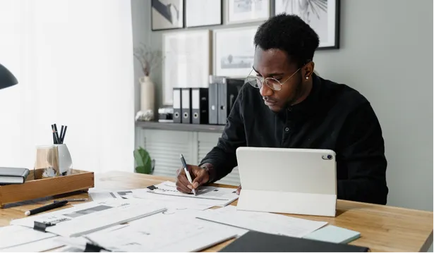man with glasses writing