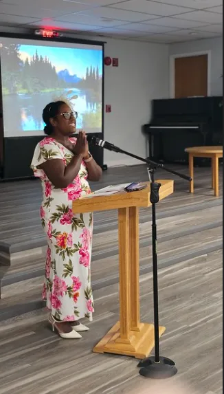 man in blue denim top standing under tree leaf