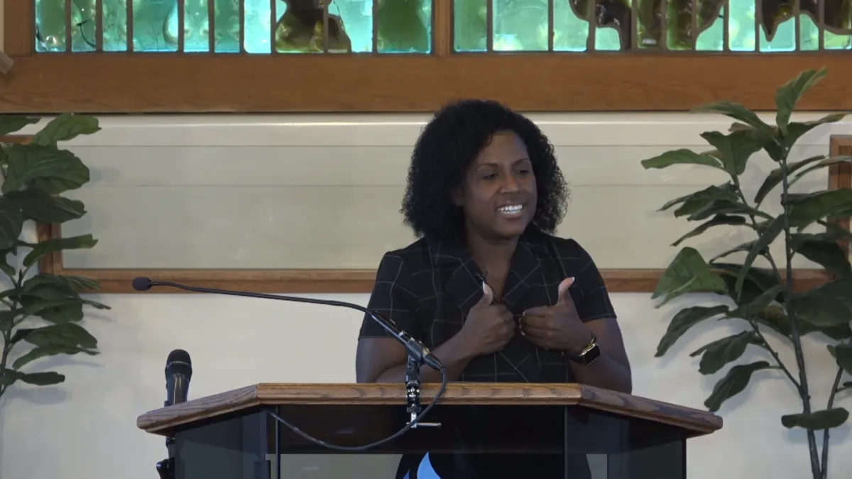 a man sitting on the ground in front of a building