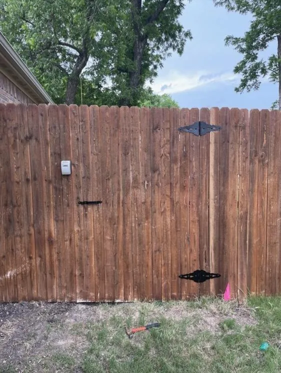 Skillfully restored wood fence by Hand in Hand Contracting, Dallas Fort Worth - Expert repair and craftsmanship on display