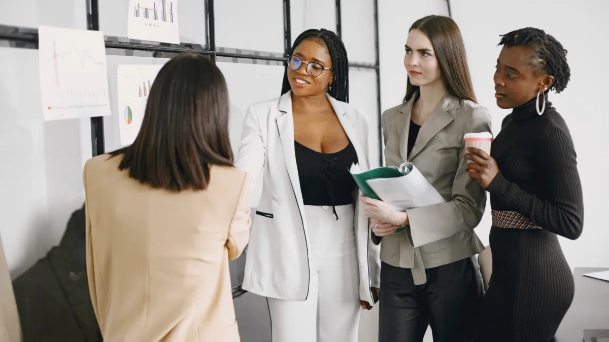 A mentor and a first-time author in a cozy office, reviewing manuscript pages together, both smiling and focused, surrounded by writing tools and motivational quotes. 1:1 aspect ratio, warm lighting.