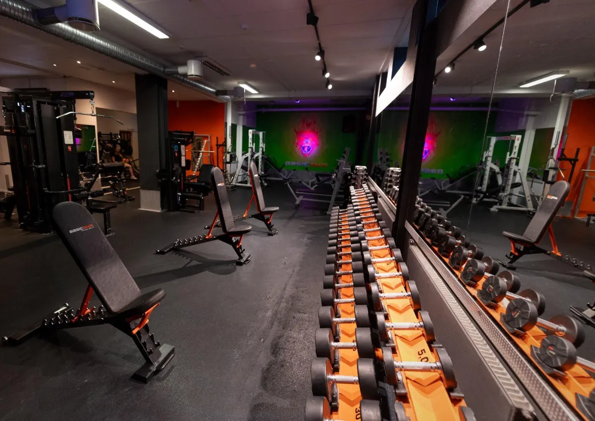 a man and a woman doing push ups with kettles