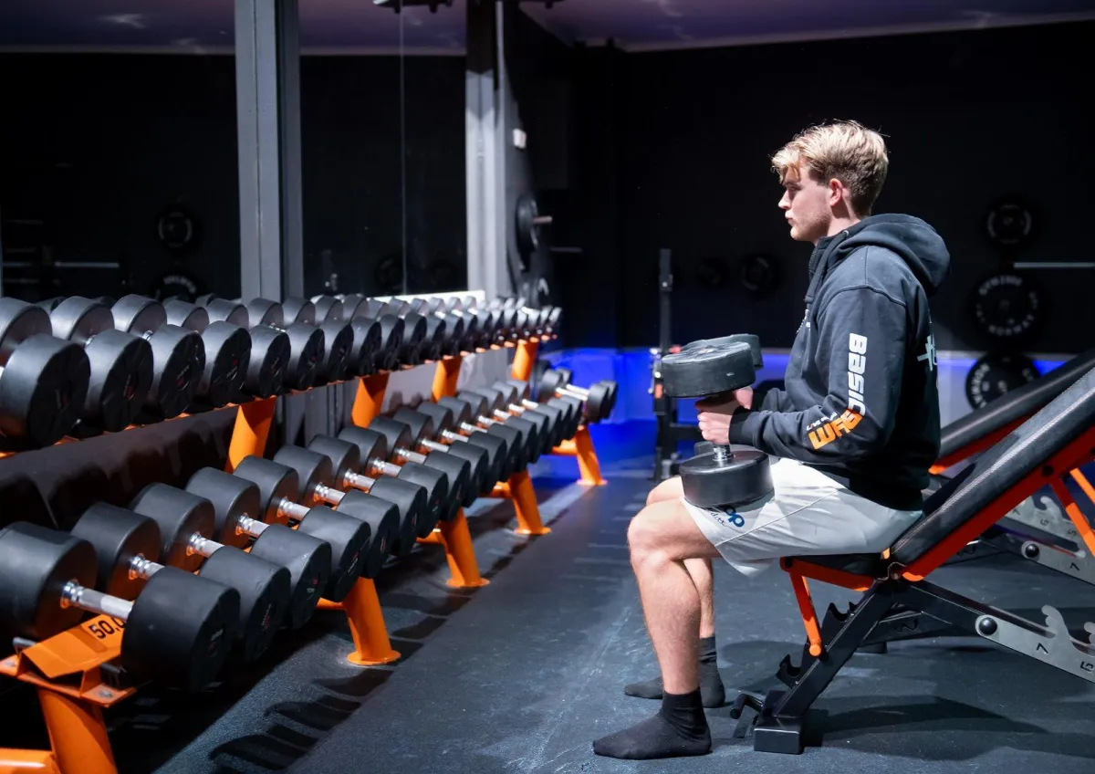 three person lifting barbels