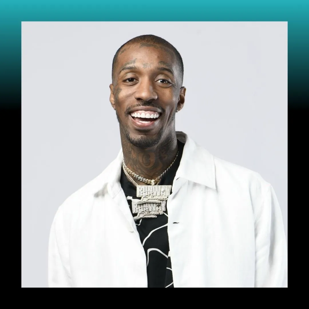 Headshot of a smiling man in a suit against a blue background