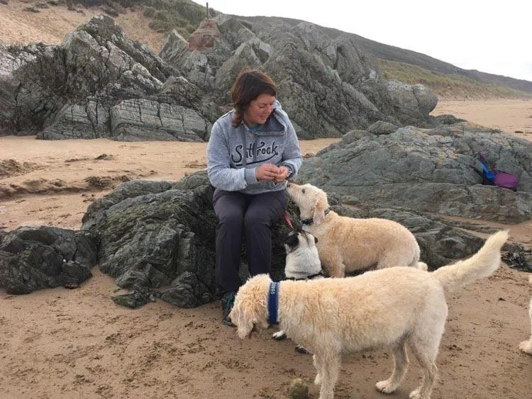 Sam Hughes Head Trainer using reward based training  with with her dogs on Wollacombe beachher dogs in Woolacombe Bay