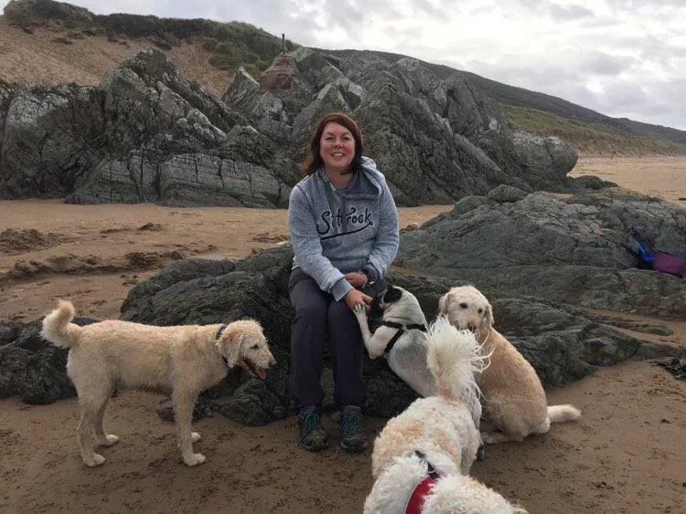 Sam Hughes Head Trainer with her dogs in Woolacombe Bay