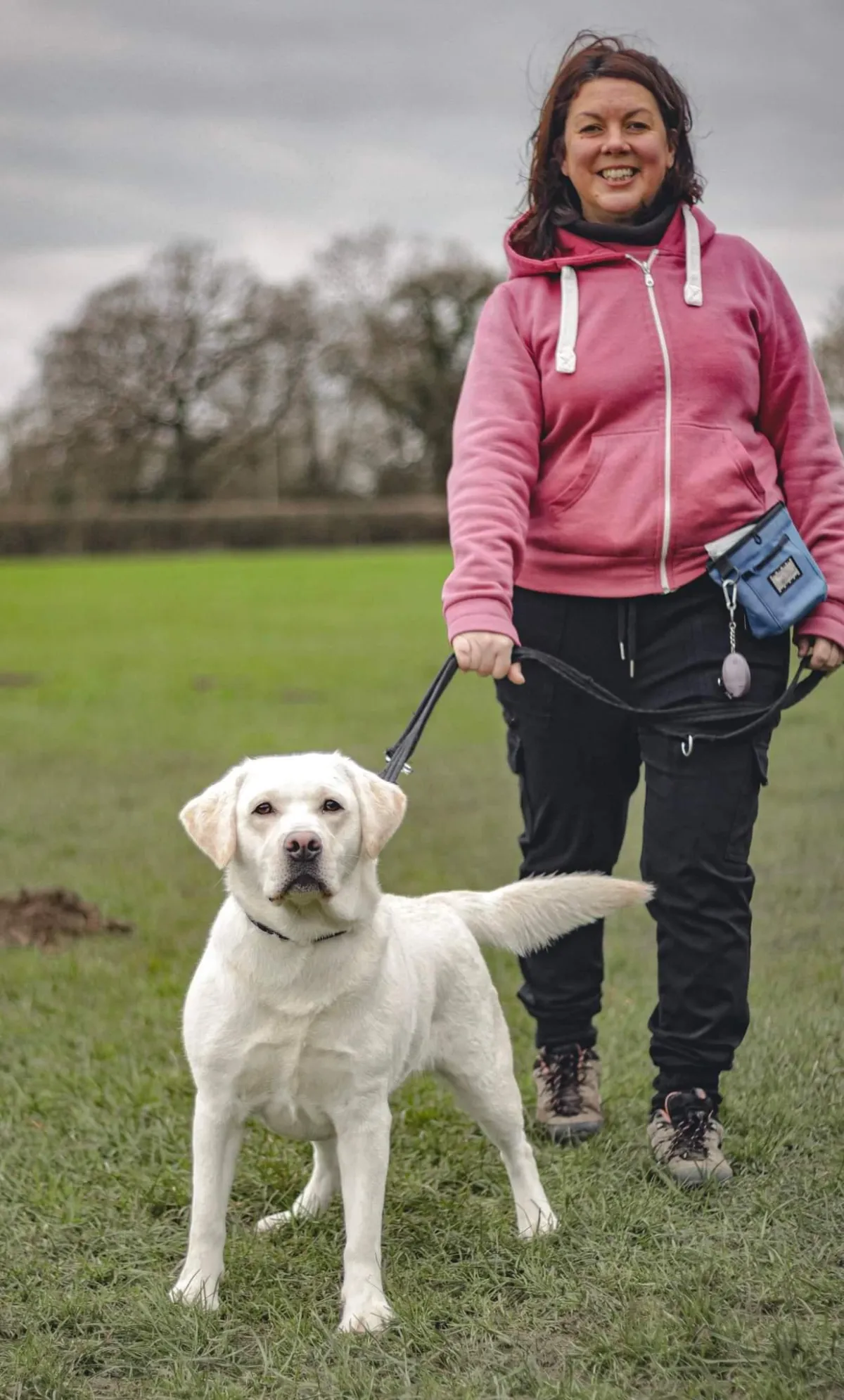 Sam Hughes Head Trainer with yellow labrador who was in the loose lead walking workshop due to pulling on its lead and the owners wanted him to walk nicely.