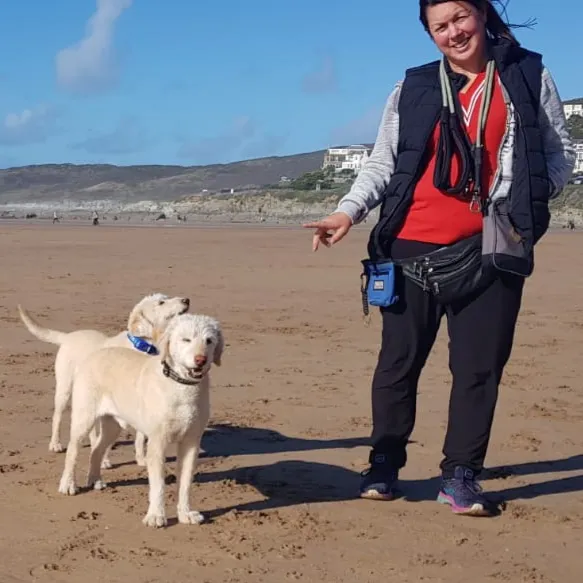 Sam Hughes Head Trainer with her dogs in Woolacombe Bay