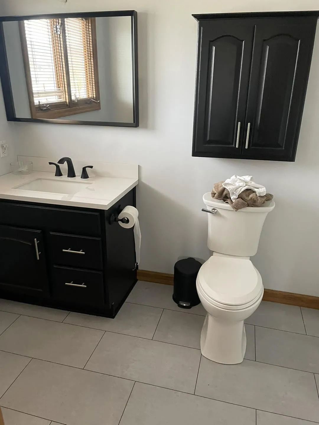 Modern bathroom remodel with new floor and sink