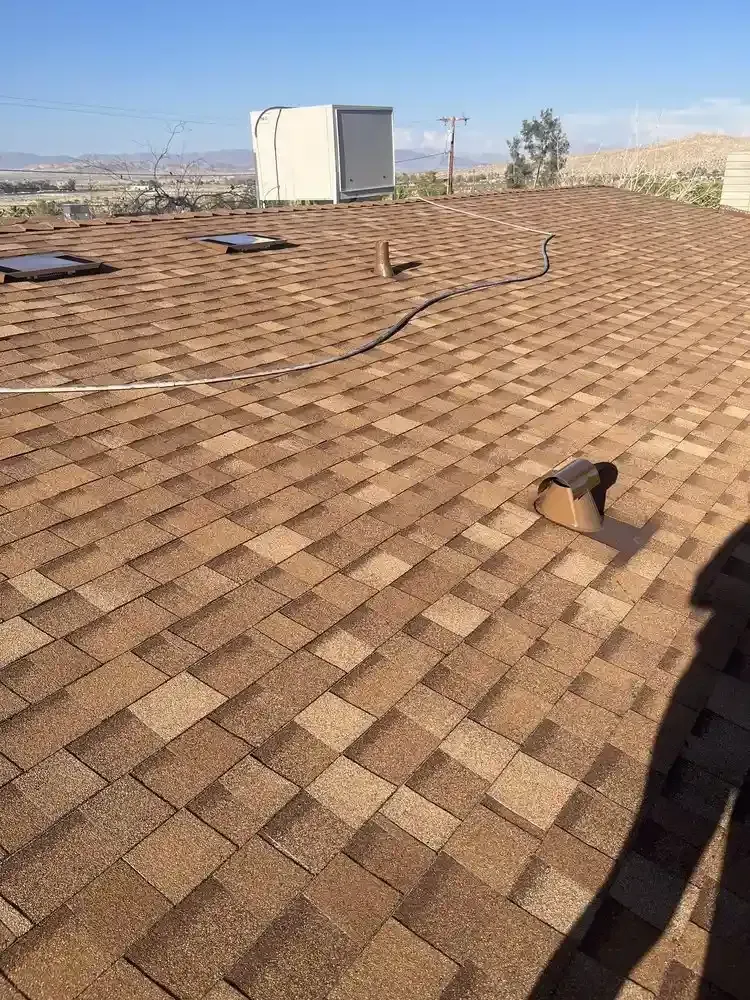Completed brown asphalt shingle roof on single-story desert home — roof replacement Palm Desert