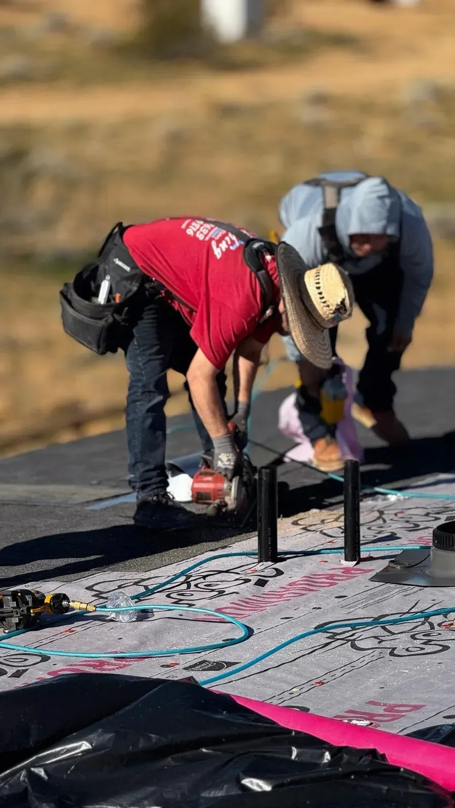 Roofing crew laying underlayment on residential roof deck — best roofing company Inland Empire CA