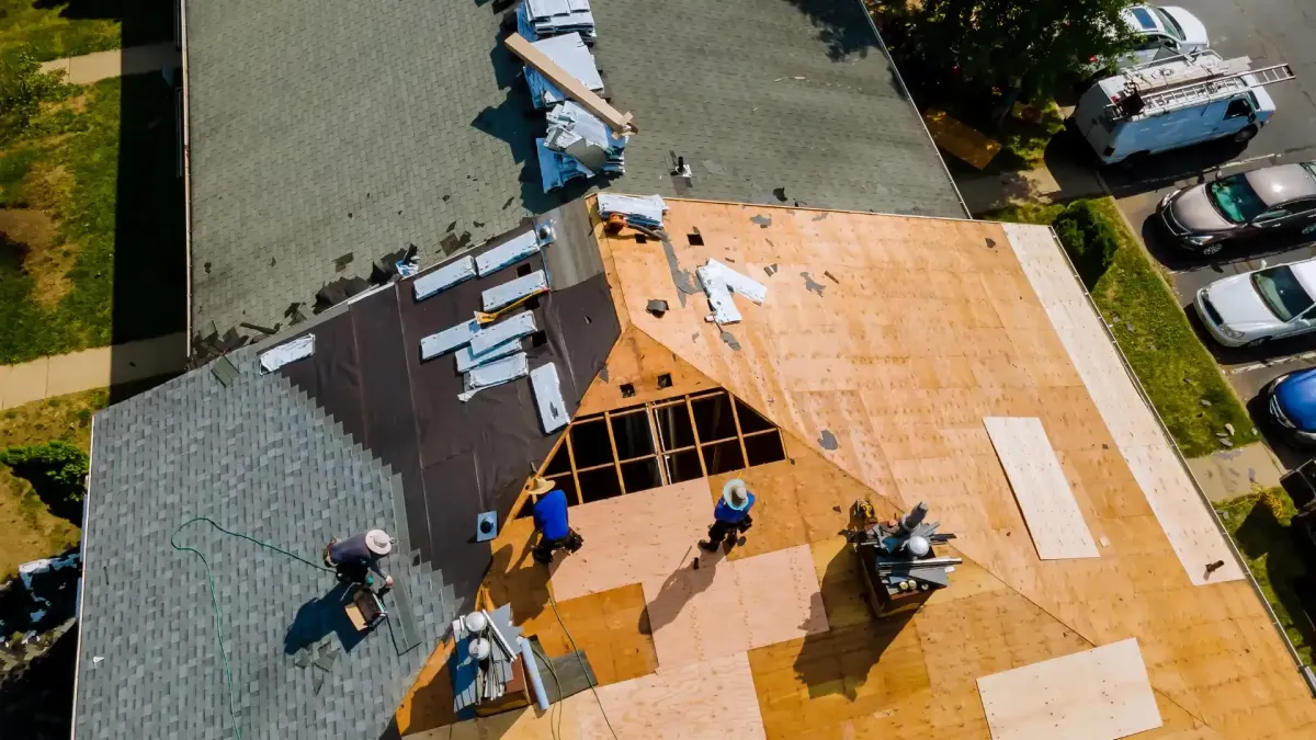 Aerial of crew tearing off old shingles and re-decking a home — roofing contractor near me Palm Springs