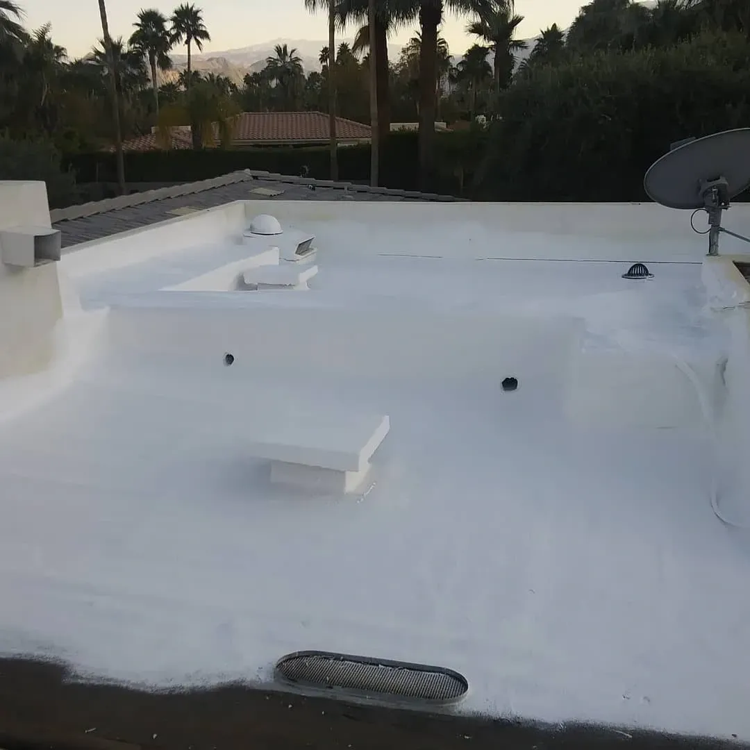 Completed white spray foam cool roof system on  Coachella Valley residential property by Dove Roofing