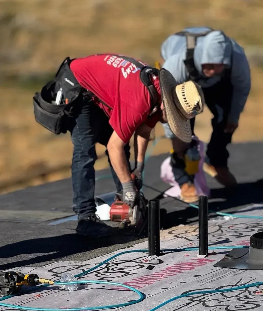 Crew laying underlayment on new roof deck under desert sun — roofing services Southern California