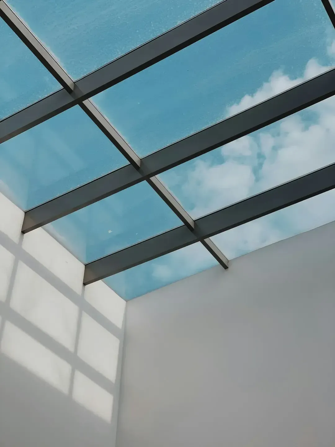 Modern glass skylight roof structure allowing natural light.