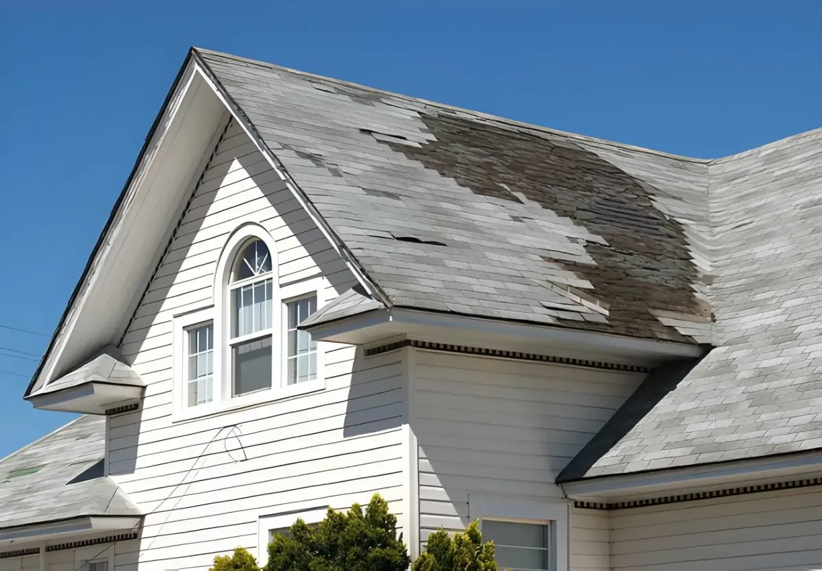 Damaged, curling asphalt shingle roof on a Riverside home in need of replacement