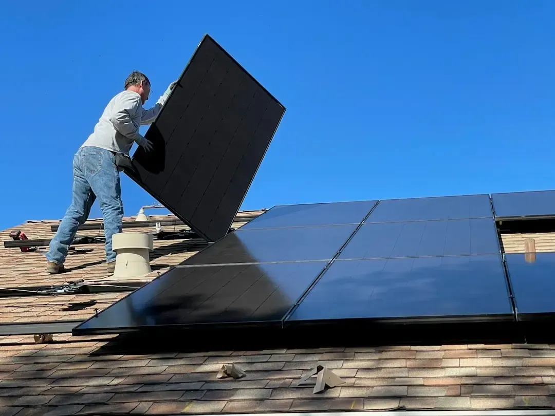 Roofer installing solar panels on a residential roof in Rancho Mirage, CA.