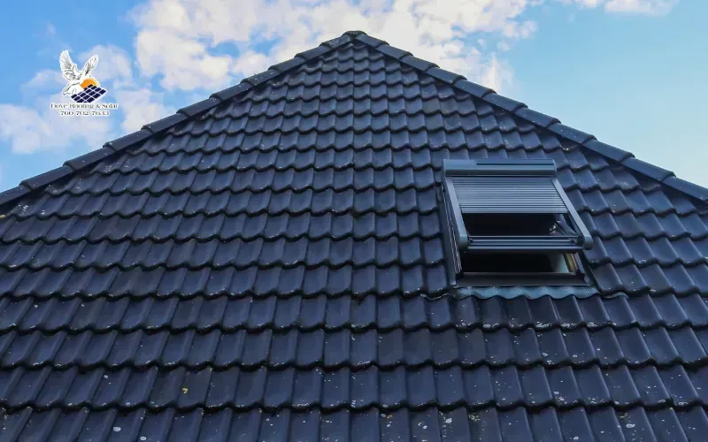 Dark tile roof with skylight installed by Dove Roofing in Indio