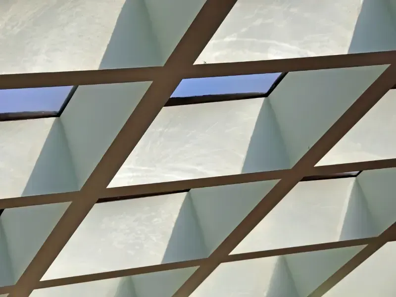 Diamond-grid patterned atrium skylight ceiling viewed from below