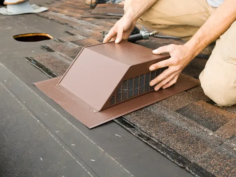 Roofer installing a roof vent during a roof replacement in Joshua Tree, CA.
