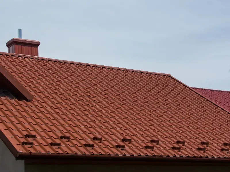 Red clay tile roof with chimney on a Southern California home