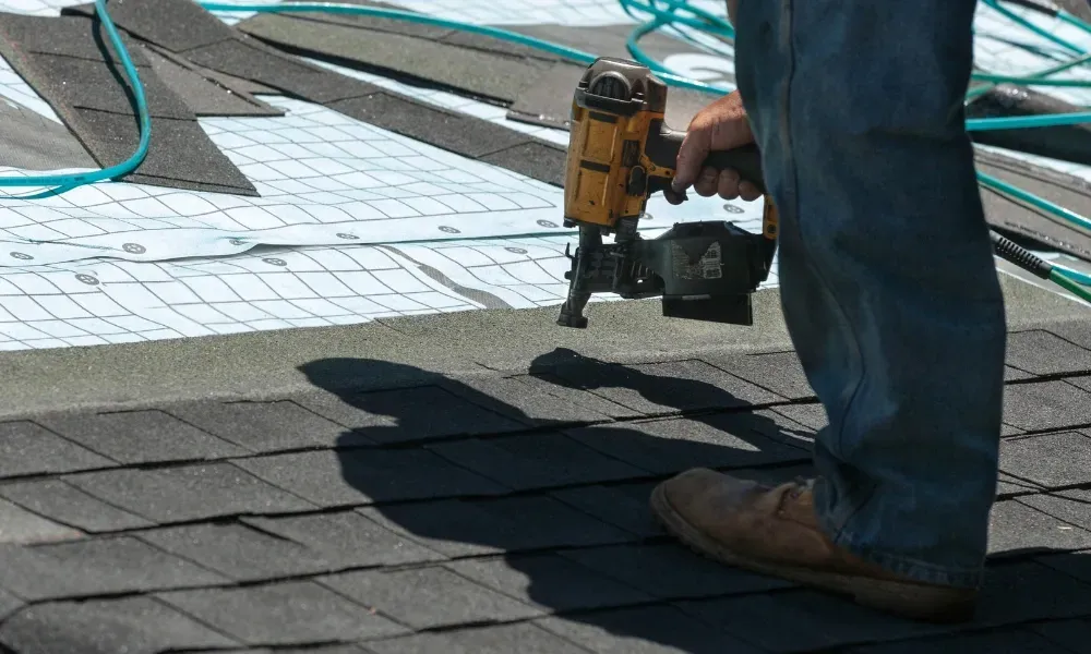 Aerial of crew tearing off old shingles and re-decking a home — roofing contractor near me Palm Springs