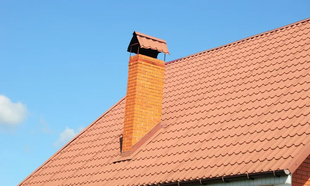 Close-up of pneumatic nail gun fastening new asphalt shingles — how do you install roof shingles