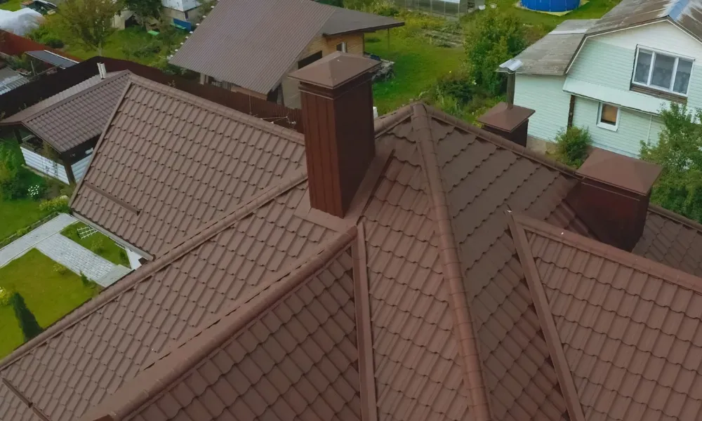 Close-up of pneumatic nail gun fastening new asphalt shingles — how do you install roof shingles