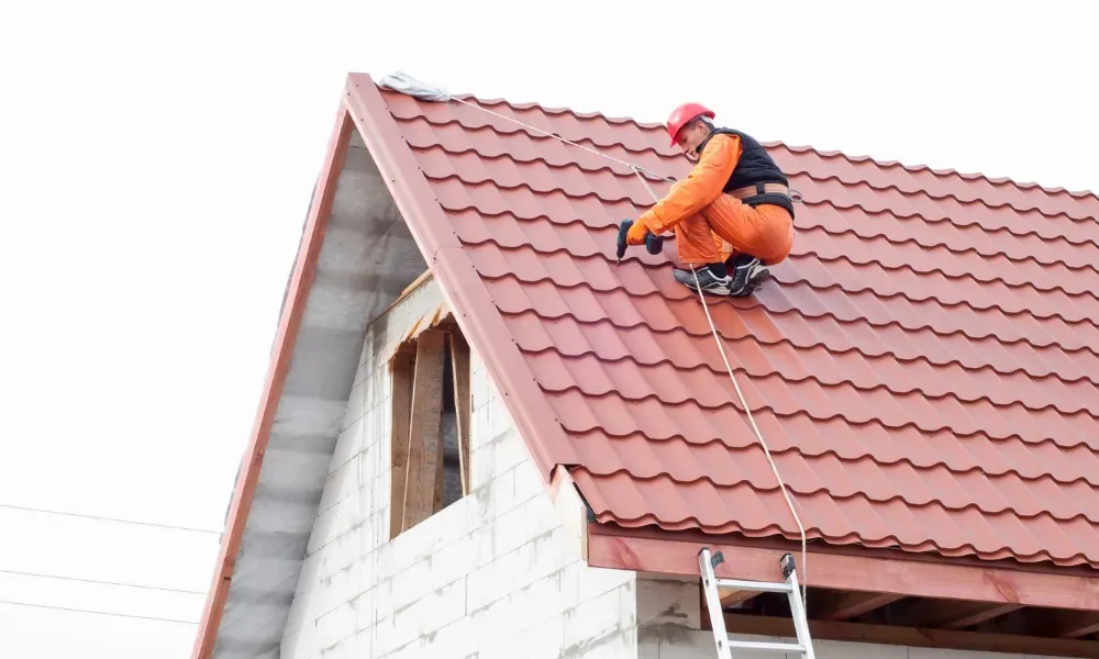 Hand lifting damaged shingle revealing gap at eave — what are signs of roof damage after a storm