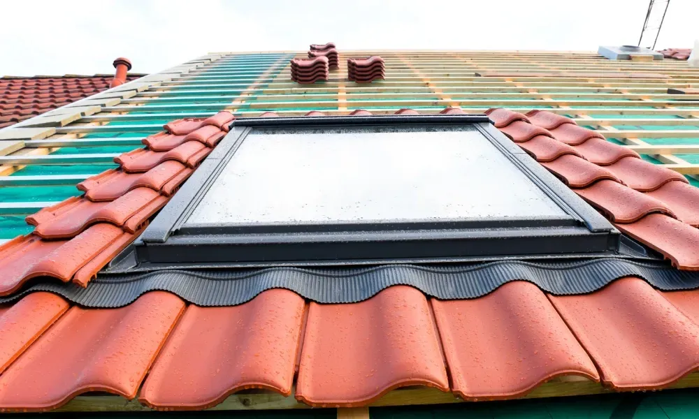 Hand lifting damaged shingle revealing gap at eave — what are signs of roof damage after a storm