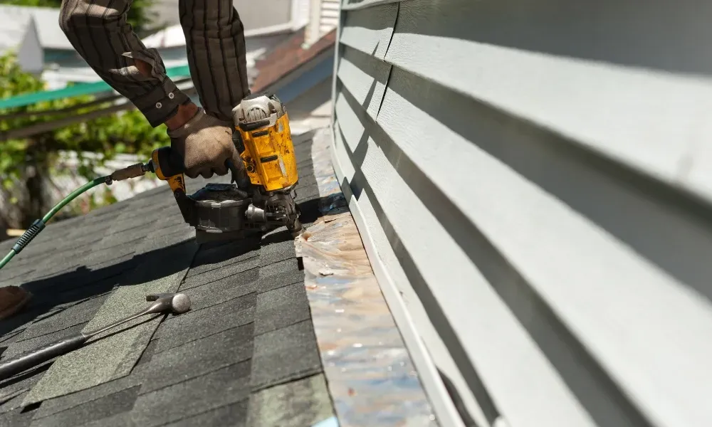 Aerial of crew tearing off old shingles and re-decking a home — roofing contractor near me Palm Springs