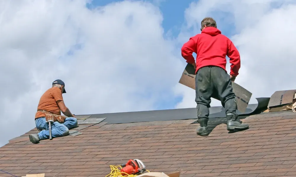Torch flame heat-welding bituminous membrane on flat roof — what is the best roofing material for a flat roof