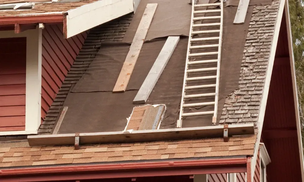 Aerial of crew tearing off old shingles and re-decking a home — roofing contractor near me Palm Springs