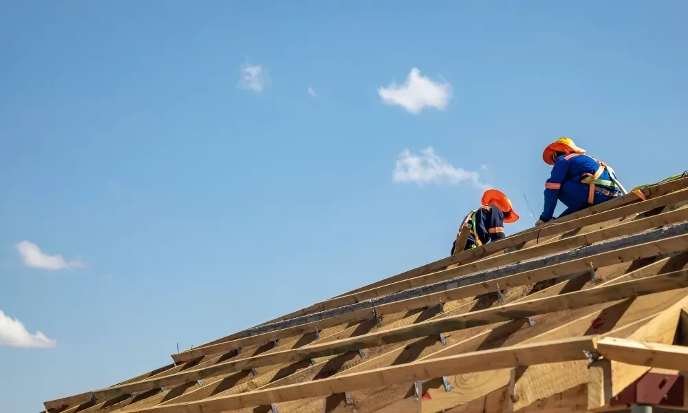 Aerial of crew tearing off old shingles and re-decking a home — roofing contractor near me Palm Springs
