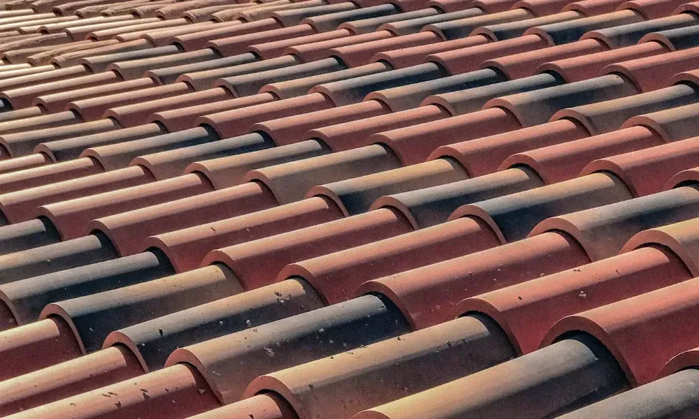 Torch flame heat-welding bituminous membrane on flat roof — what is the best roofing material for a flat roof